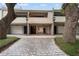 Townhouse exteriors with garage access and tree-lined walkways at 301 2Nd N St # 14, St Petersburg, FL 33701