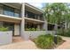 Modern townhouse featuring a private entrance, balconies, and manicured landscaping at 301 2Nd N St # 14, St Petersburg, FL 33701