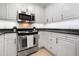 White kitchen with modern appliances, granite countertops, and ample cabinet space at 301 2Nd N St # 14, St Petersburg, FL 33701