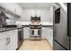 Updated kitchen features stainless steel appliances, white cabinetry, and granite countertops at 301 2Nd N St # 14, St Petersburg, FL 33701