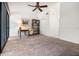 Open living room area with carpet, a ceiling fan and built-in shelving at 301 2Nd N St # 14, St Petersburg, FL 33701