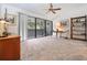 Inviting living room with a sliding glass doors to the balcony and decorative art with carpet flooring at 301 2Nd N St # 14, St Petersburg, FL 33701