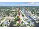 Overhead view of the house surrounded by canals, lush greenery, and well-maintained properties at 336 Westwinds Cir, Palm Harbor, FL 34683