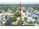 Waterfront home featuring a private dock, lush landscaping, and access to a tranquil canal at 336 Westwinds Cir, Palm Harbor, FL 34683