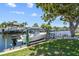 Private dock with a boat lift, perfect for enjoying waterfront living and boating activities at 336 Westwinds Cir, Palm Harbor, FL 34683