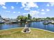 Scenic canal view showcasing multiple docks, boats, and waterfront homes in the distance at 336 Westwinds Cir, Palm Harbor, FL 34683