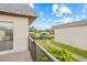 This beautiful home has a balcony that overlooks a serene landscape with a bridge and verdant green grass at 3368 Ramblewood Pl # 37-D-1, Sarasota, FL 34237