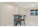 Breakfast bar and seating feature a decorative backsplash and a contemporary textured accent wall at 3368 Ramblewood Pl # 37-D-1, Sarasota, FL 34237