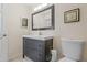 Stylish bathroom featuring a modern vanity, toilet, and framed mirror, offering a clean and contemporary aesthetic at 3368 Ramblewood Pl # 37-D-1, Sarasota, FL 34237