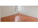 This bedroom features beautiful hardwood floors and a bright window, creating a warm and inviting atmosphere at 3368 Ramblewood Pl # 37-D-1, Sarasota, FL 34237