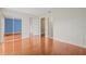 Large bedroom with hardwood floors featuring mirrored closet, doorway and ensuite access providing comfort and style at 3368 Ramblewood Pl # 37-D-1, Sarasota, FL 34237