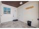 Tiled entryway featuring a window, front door, and wall-mounted coat rack at 3368 Ramblewood Pl # 37-D-1, Sarasota, FL 34237