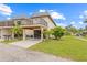 Two-story townhome with a balcony, carport, and well-maintained lawn and landscape at 3368 Ramblewood Pl # 37-D-1, Sarasota, FL 34237