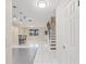 Inviting foyer with an open layout to the living area, stairs, and a view of the kitchen at 3368 Ramblewood Pl # 37-D-1, Sarasota, FL 34237
