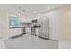 Bright kitchen features stainless steel appliances, white cabinets, and tile flooring at 3368 Ramblewood Pl # 37-D-1, Sarasota, FL 34237