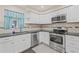 Updated kitchen featuring stainless steel appliances, dark countertops, and white cabinetry at 3368 Ramblewood Pl # 37-D-1, Sarasota, FL 34237
