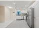 Bright kitchen with stainless steel appliances, white cabinetry, and gray tiled flooring at 3368 Ramblewood Pl # 37-D-1, Sarasota, FL 34237