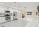 Modern open kitchen with stainless steel appliances, tile backsplash, and a breakfast bar with seating at 3368 Ramblewood Pl # 37-D-1, Sarasota, FL 34237