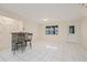 Bright living room with tiled floors, bar area, and a rear door at 3368 Ramblewood Pl # 37-D-1, Sarasota, FL 34237