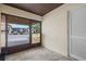 Enclosed porch with tile flooring and large sliding windows overlooking a parking area at 3368 Ramblewood Pl # 37-D-1, Sarasota, FL 34237