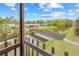 Scenic view from a screened-in patio overlooking a pond with a bridge and vibrant landscaping at 3368 Ramblewood Pl # 37-D-1, Sarasota, FL 34237