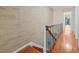 Staircase with wood treads and decorative stone wall at 3368 Ramblewood Pl # 37-D-1, Sarasota, FL 34237