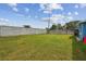 Large fenced backyard with a grassy area, offering privacy and space for outdoor enjoyment at 3427 Cantrell St, Holiday, FL 34690