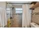 Modern bathroom featuring tiled walls, a shower with curtain, and stylish fixtures at 3427 Cantrell St, Holiday, FL 34690