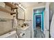 A bathroom featuring a vanity, tiled backsplash, and wood-look floors, offering a modern design at 3427 Cantrell St, Holiday, FL 34690