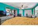 Spacious bedroom features hardwood floors, a ceiling fan, and a dressing area at 3427 Cantrell St, Holiday, FL 34690
