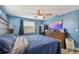 Bedroom features hardwood floors, a ceiling fan, a window view, and a large dresser at 3427 Cantrell St, Holiday, FL 34690