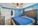 Large bedroom features hardwood floors, a ceiling fan, a closet and a dresser at 3427 Cantrell St, Holiday, FL 34690