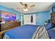 A comfortable bedroom with a ceiling fan, blue walls, a TV, and a large dresser at 3427 Cantrell St, Holiday, FL 34690