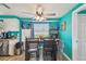 Eat-in kitchen features a wooden table and chairs, open shelving, and a view from the window at 3427 Cantrell St, Holiday, FL 34690