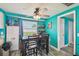 Eat-in kitchen features a wooden table and chairs, open shelving, and a view from the window at 3427 Cantrell St, Holiday, FL 34690
