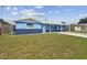 Comfortable single-story home with a green lawn and a covered front porch, with a blue exterior at 3427 Cantrell St, Holiday, FL 34690