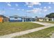 Inviting single-story home with a green lawn and a covered front porch, with blue exterior at 3427 Cantrell St, Holiday, FL 34690