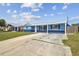 Comfortable single-story home with a green lawn and a covered front porch, boasting a blue exterior at 3427 Cantrell St, Holiday, FL 34690