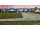 Charming single-story home with a well-maintained lawn and a covered front porch, painted in blue and dark blue hues at 3427 Cantrell St, Holiday, FL 34690
