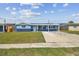 Inviting single-story home with a green lawn and a covered front porch, with blue exterior at 3427 Cantrell St, Holiday, FL 34690