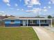 Charming single-story home featuring a covered entrance, updated paint, manicured lawn, and a spacious driveway at 3427 Cantrell St, Holiday, FL 34690