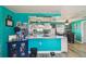 Modern kitchen with white cabinetry, sleek granite countertops, stainless steel appliances, and a connected dining area at 3427 Cantrell St, Holiday, FL 34690