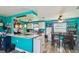 Open kitchen and dining area features white cabinets, granite countertops, and eat in breakfast bar at 3427 Cantrell St, Holiday, FL 34690