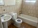 Bathroom with classic tile, toilet, sink, and bathtub at 3518 16Th S Ave, St Petersburg, FL 33711
