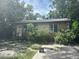The home's front exterior features stone details and mature trees in the surrounding landscape at 3518 16Th S Ave, St Petersburg, FL 33711