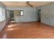 Spacious living room with damaged floors and partial wall into kitchen at 3518 16Th S Ave, St Petersburg, FL 33711