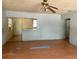 View of living room with partial wall overlooking kitchen and damaged flooring at 3518 16Th S Ave, St Petersburg, FL 33711