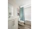 Charming bathroom featuring a modern vanity, toilet, and a bathtub with a vibrant patterned shower curtain at 36972 Sagemoor Dr, Zephyrhills, FL 33541