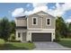 Charming two-story home featuring neutral siding, a paved driveway, manicured lawn, and attached two-car garage at 36972 Sagemoor Dr, Zephyrhills, FL 33541
