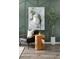 Stylish green-themed living room features an accent chair, modern lamp, and a tall plant against the geometric wall at 36972 Sagemoor Dr, Zephyrhills, FL 33541